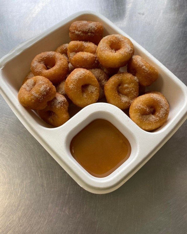 Flipside Donuts in a tray with caramel sauce at On the Fly River Festival in Gore Southland 