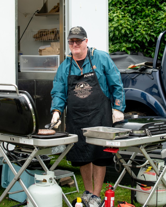 A man from Southland Biltong cooking the BBQ at On the Fly Festival in Gore Southland. 